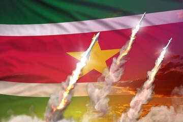 Modern strategic rocket forces concept on sunset background, Suriname supersonic warhead attack - military industrial 3D illustration, nuke with flag