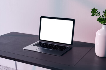 Laptop on wooden desk with clean setup, shadow play from natural light, mockup concept. 3D Rendering