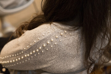 Woolen jacket decorated with artificial pearls.