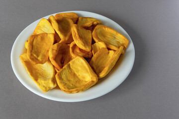 Keripik Sukun or Breadfruit Chips is a food made from breadfruit on a white plate
