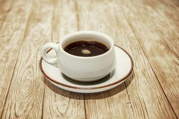 cup of coffee on wooden table