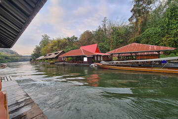 Obraz premium A peaceful riverside resort with traditional wooden houses