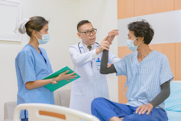Fototapeta premium Doctor checking blood pressure to a patient. The doctor is inserting a device into the arm to measure blood pressure for a physical examination.