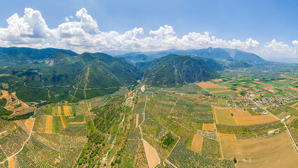 Lamia, Phthiotis, Greece. Panorama of the valley with fields. Olive trees, colorful fields. Summer, Cloudy weather. Aerial view