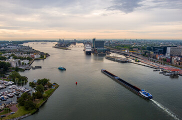 Amsterdam, Netherlands. A barge with coal floats on the water. Bay IJ. (Amsterdam). Panorama of the...