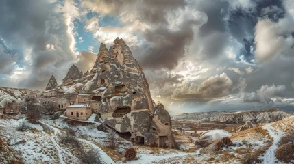 Fototapeten It was a cloudy day in January at the cave fortress city of Uchisar in Cappadocia, Turkey. © Emil