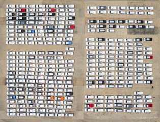 Top view of new cars stock at factory parking lot. Above view cars parked in a row. Automotive industry. Logistics business. Import or export new cars at warehouse. Big parking lot at port terminal