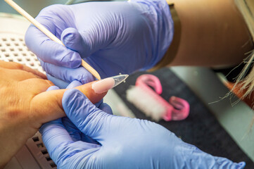 Manicure process in beauty salon, close up