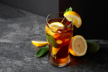 Iced tea or a summer refreshing drink with ice, mint, and lemon.