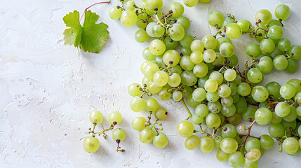 A handful of fresh, juicy grapes scattered on a white surface, displaying their plumpness and...