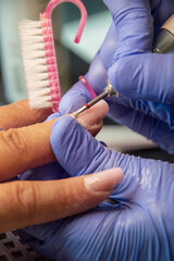 Manicure process in beauty salon, close up