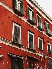 Naklejka premium Old historic Italian architecture. Red traditional European old town building in Naples, Italy. Vacation travel background