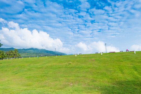 Green meadows with blue sky and clouds background, Landscape view of green grass on slope Scenic panoramic view on a beautiful sunny day,japanese picture concept.