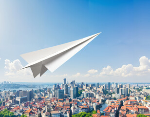 A paper airplane flying over a cityscape, symbolizing the freedom and agility in entrepreneurial pursuits - obrazy, fototapety, plakaty