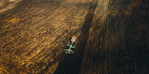 Aerial View. Tractor Plowing Field In Spring Season. Beginning Of Agricultural Spring Season. Cultivator Pulled By A Tractor In Countryside Rural Field Landscape. - 766170561