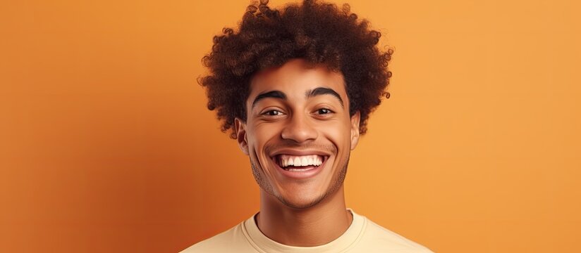 Portrait of a cheerful man with a bouncy afro hairstyle flashing a big smile
