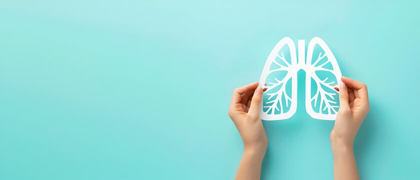 Hands holding a white paper cut out of lungs