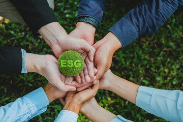 group of Business people joining hands together with global community teamwork and group of Business people holding earth environmentally together sustainable Save Earth.