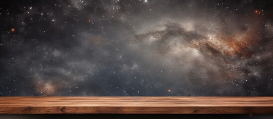 An image of a table made of wood, with a clear view of the galaxy in the background