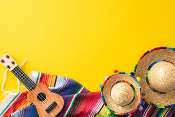 Cinco de Mayo assortment. Top view picture of party gear: tiny hats, a crafted vihuela, a colorful...