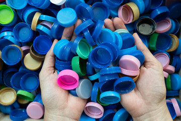 woman hand holding plastic bottles caps for recycling to conserve the environment, Recycling,...