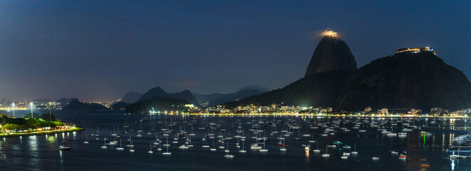 Nighttime Panorama of Rio de Janeiro with Illuminated Boats