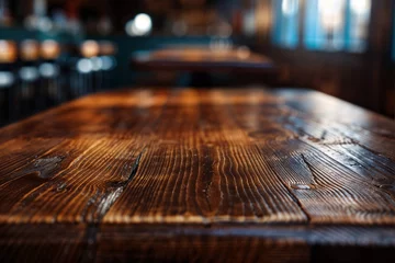 Fotobehang Empty wooden bar table with blurred bar background. High quality photo © oksa_studio