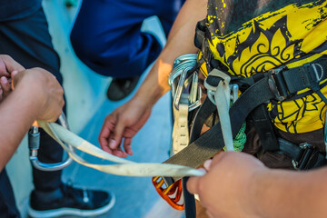 Simulation rock climbing athletes are installing safety equipment and ropes.