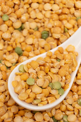 Pea yellow groats grains cereal in spoon close-up macro.