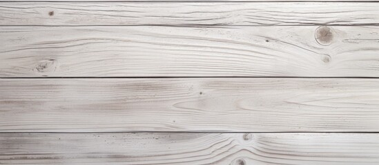 A close up of a brown hardwood plank flooring with a grey wooden surface. The rectangle pattern creates a parallel font on the wood