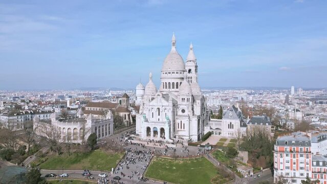 Facade of Sacre Coeur, Montmartre hill in Paris, France. Aerial drone panoramic view and sky for copy space