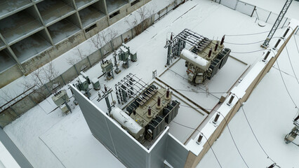 Drone photography of electrical sub station covered by snow during winter day