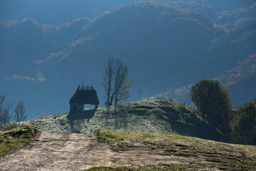 Mountain homestead in the autumn. Countryside thatched roof houses, barn