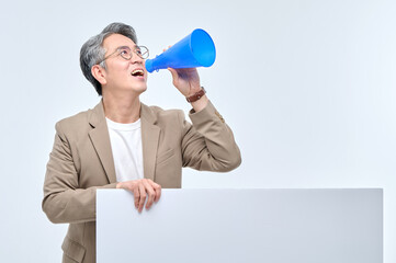 A middle-aged office worker man in a suit and glasses speaks with a blue loudspeaker and poses with various facial expressions holding a white panel.