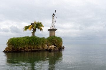 Statue in the middle of the ocean in livingstone guatemala