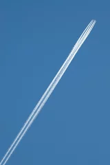 Fototapeten General stock image - Contrail behind an overflying aircraft. © Richard