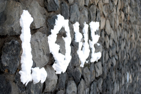 Amsterdam snow spelling love on a wall