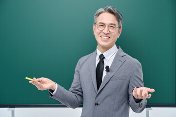 A middle-aged male teacher in a suit and glasses is giving an Internet lecture with a confident...