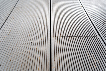 Closeup of a wooden floor with parallel striped pattern