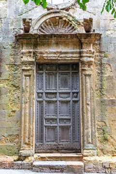 View of old medieval door of an old stone church. Vertical. 