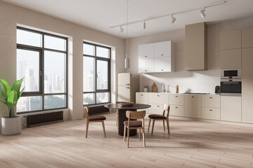 Beige home kitchen interior with eating and cooking space, panoramic window