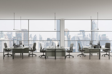 Modern office coworking interior with table and pc monitors, panoramic window