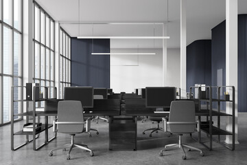 Office coworking interior with desk and pc monitors, panoramic window
