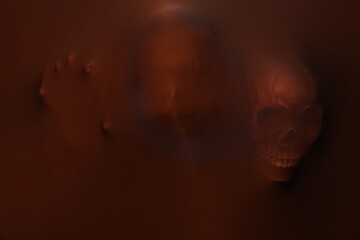 Silhouette of creepy ghost with skulls behind brown cloth