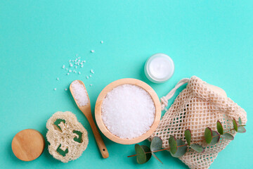 Jar of cream, body care products and eucalyptus branch on turquoise background, flat lay. Space for text