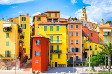 Colorful houses of Menton old town harbor at summer day, France