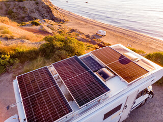 Caravan with solar panels on roof camp on coast, Spain. Aerial view. - 766247312