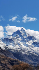 Naklejka premium Snowcovered mountain under a blue sky with fluffy clouds on the horizon. Generative AI