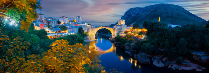 Mostar, Bosnia and Herzegovina. The Old Bridge, Stari Most, with emerald river Neretva. - obrazy, fototapety, plakaty