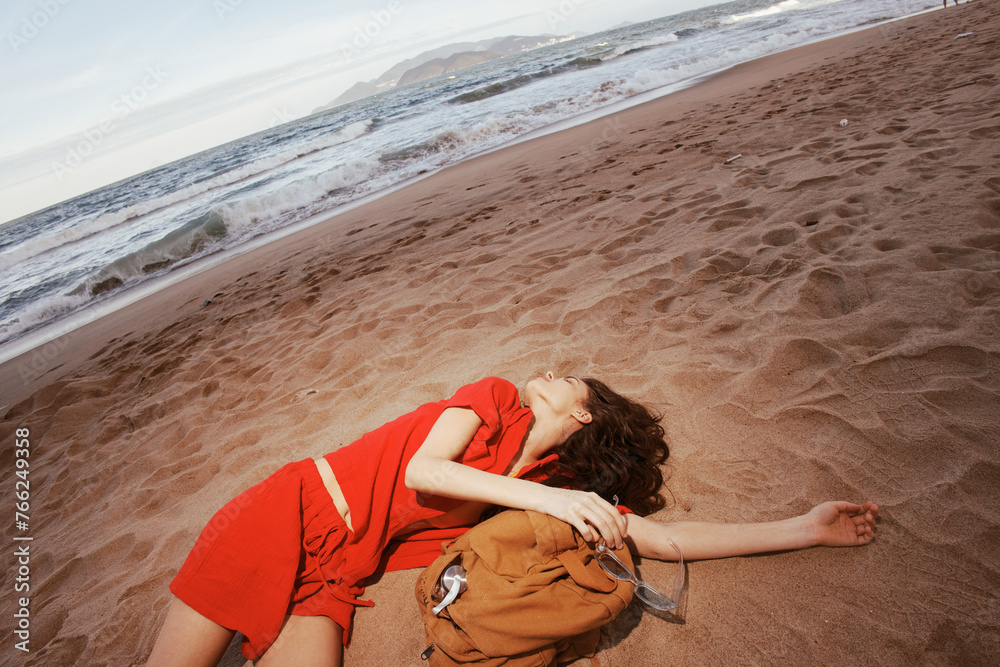 Wall mural Joyful Exploration: A Drunk Woman Relaxing on a Sandy Beach, Embracing the Freedom of Travel and Adventure